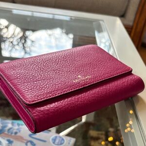 kate spade fuchsia pebbled leather bifold wallet with gold logo